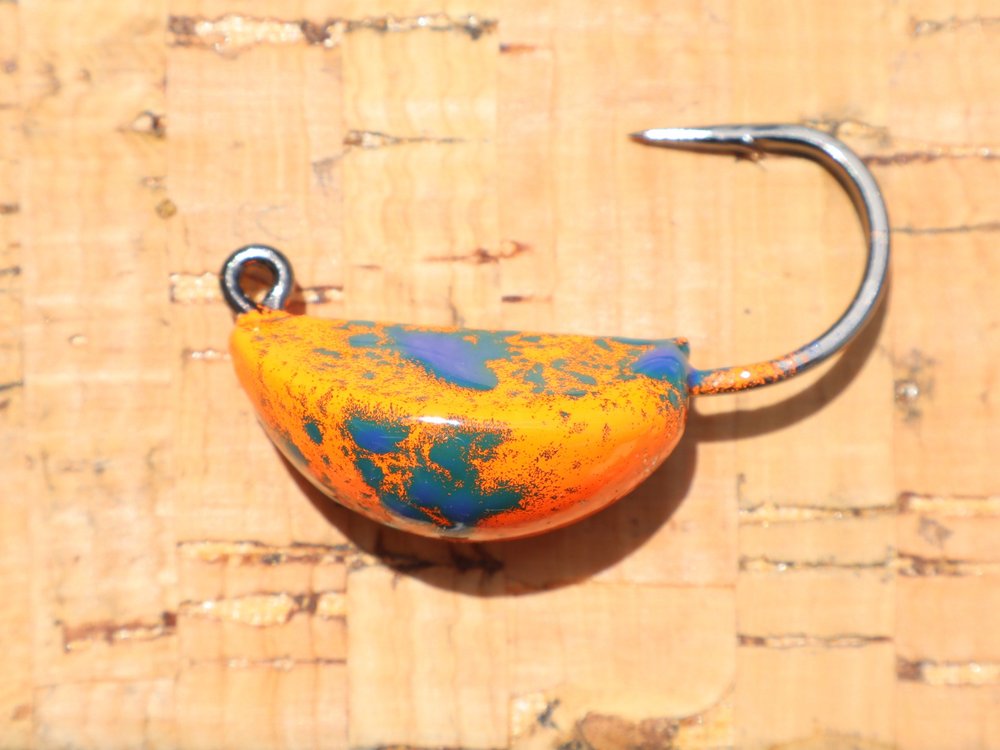 A jig head in orange, blue and teal crackle powder coat