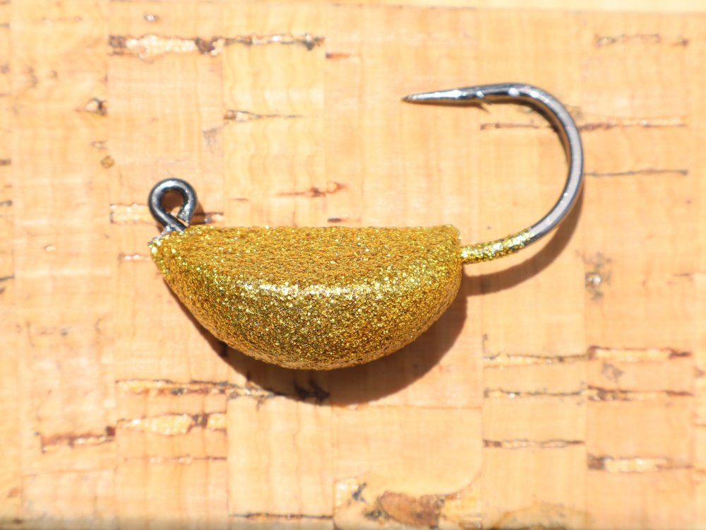 A jig head in heavy gold glitter powder coat